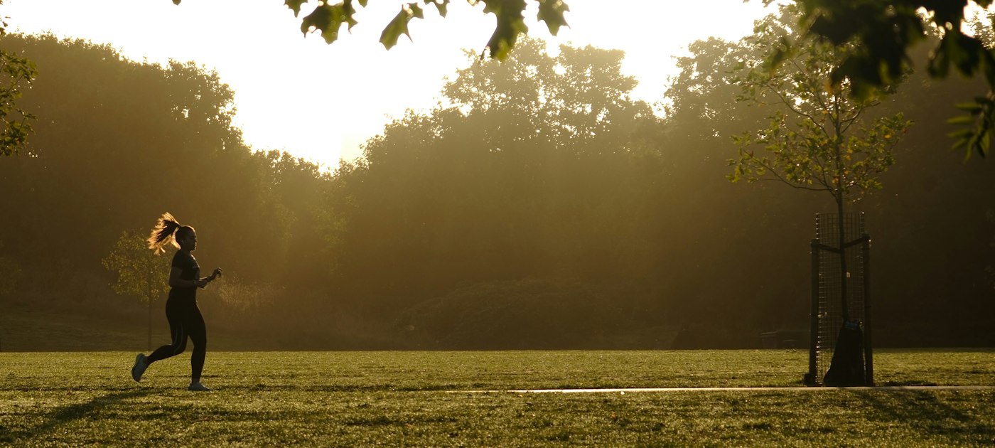 A runner training outdoors at sunset